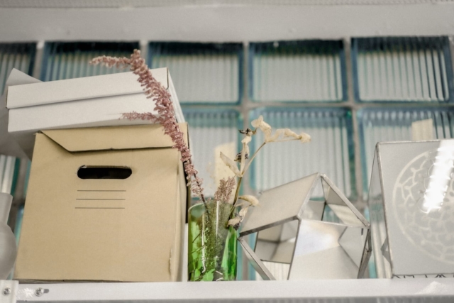 A file box with decorative flowers on the shelf.